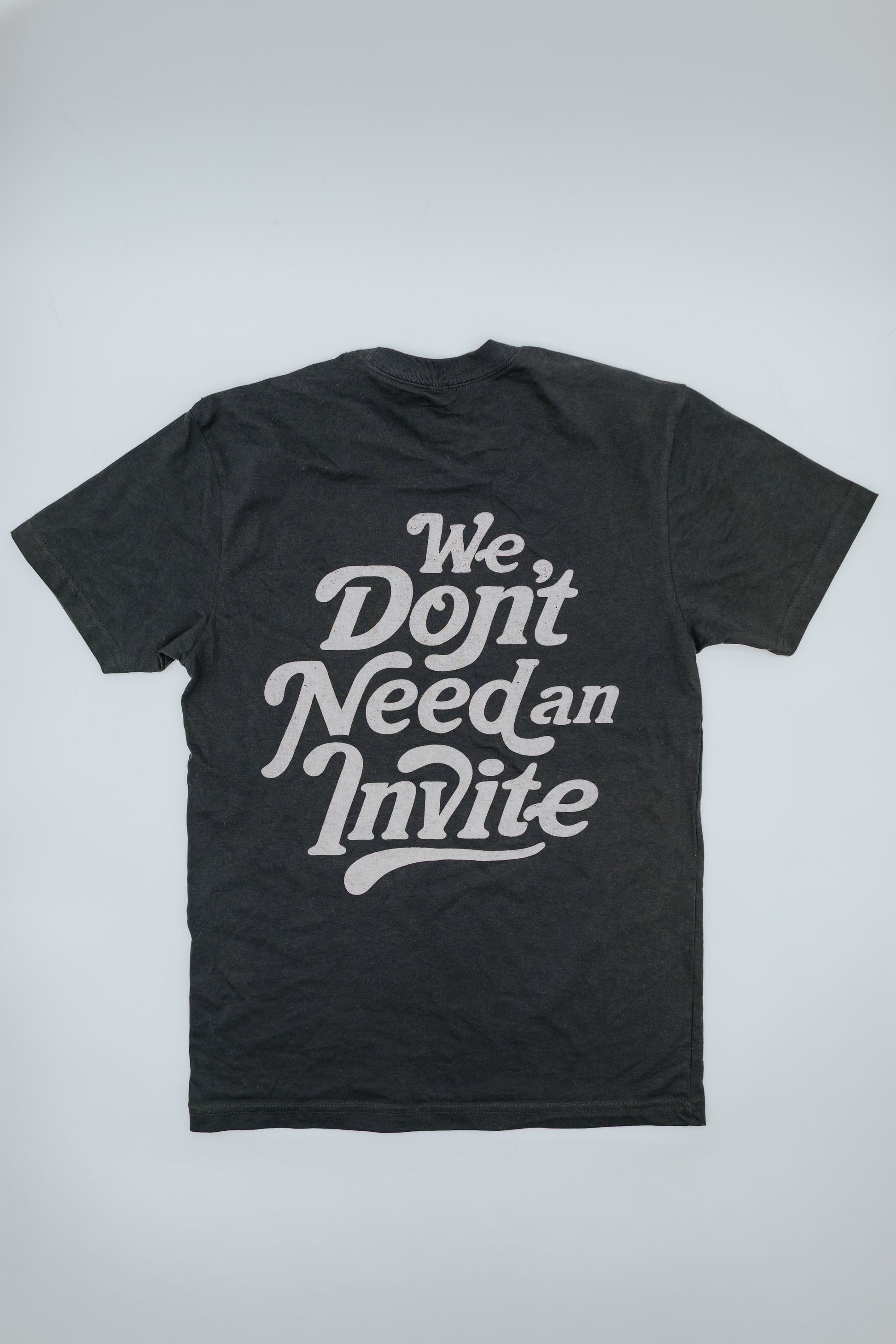 Black t-shirt with white text on a light gray background