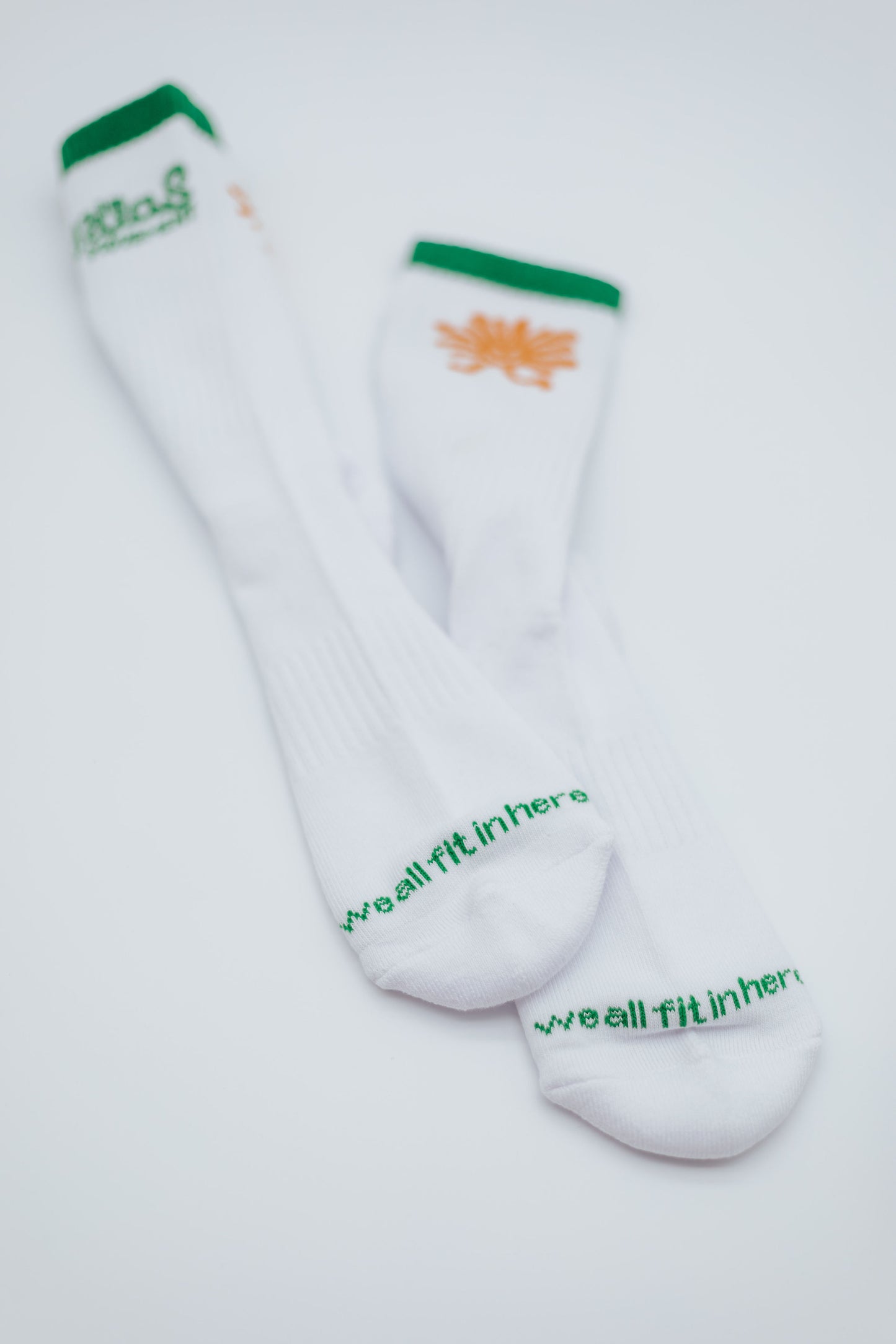 White socks with green and orange text on a white background