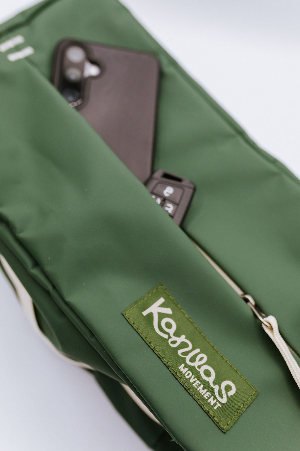 Green bag with a visible brand logo on a white background